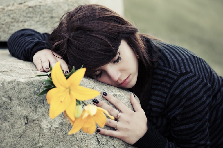 woman hugging a stone