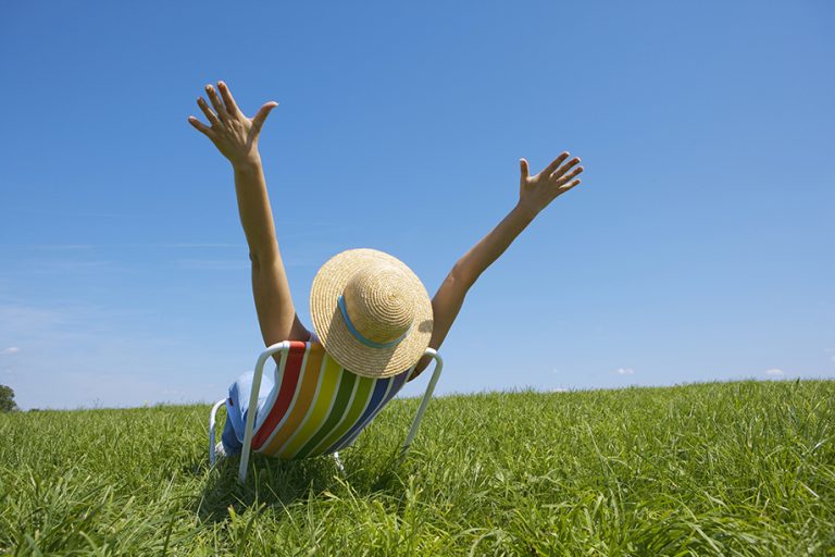 man with open arms at the field