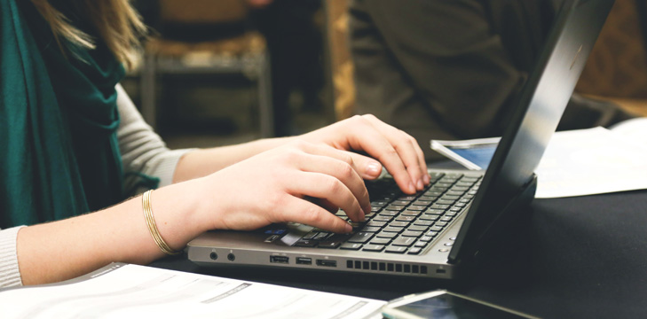 person typing on a laptop