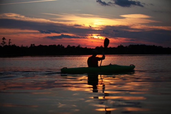 man boating on sunset