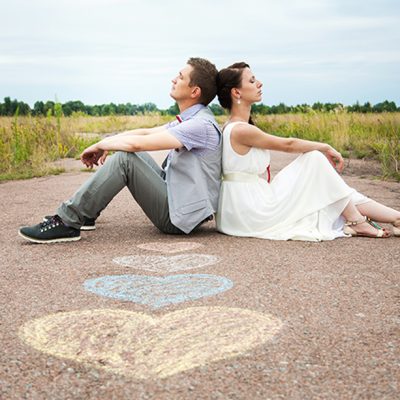 man and woman sitting on the road
