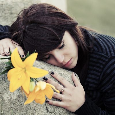woman hugging a stone