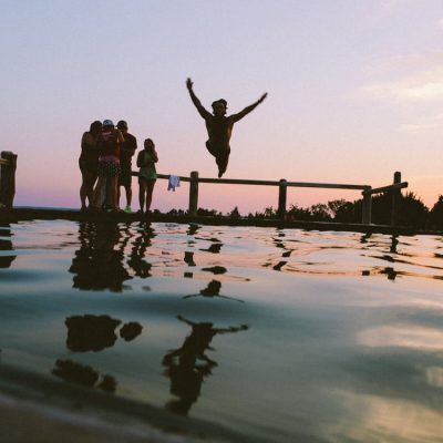 man jumping to the water