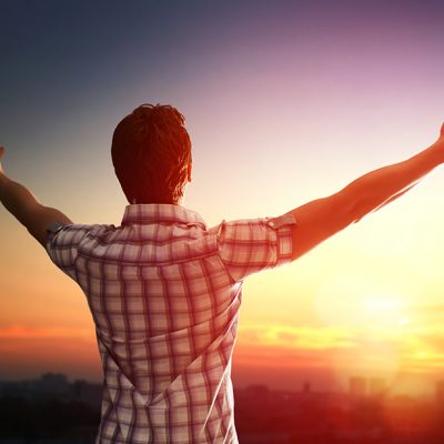 man open arms on sunset
